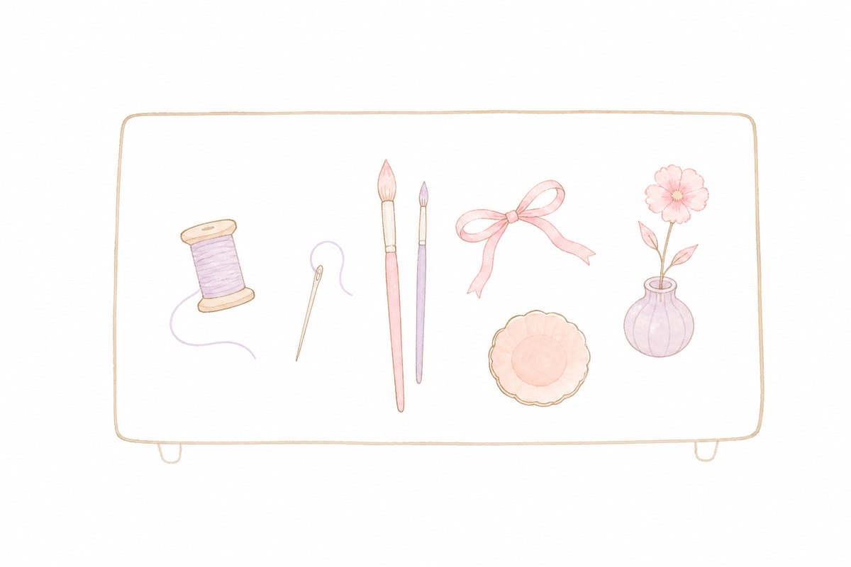 机の上に並んだ糸巻き・筆・道具のイラスト